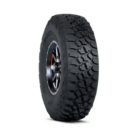 Atv Dekk 32x10-15 Itp Tenacity Xnr, skrå forfra med grovt mønster og felgdetaljer i sort, sølv og rød/blå.